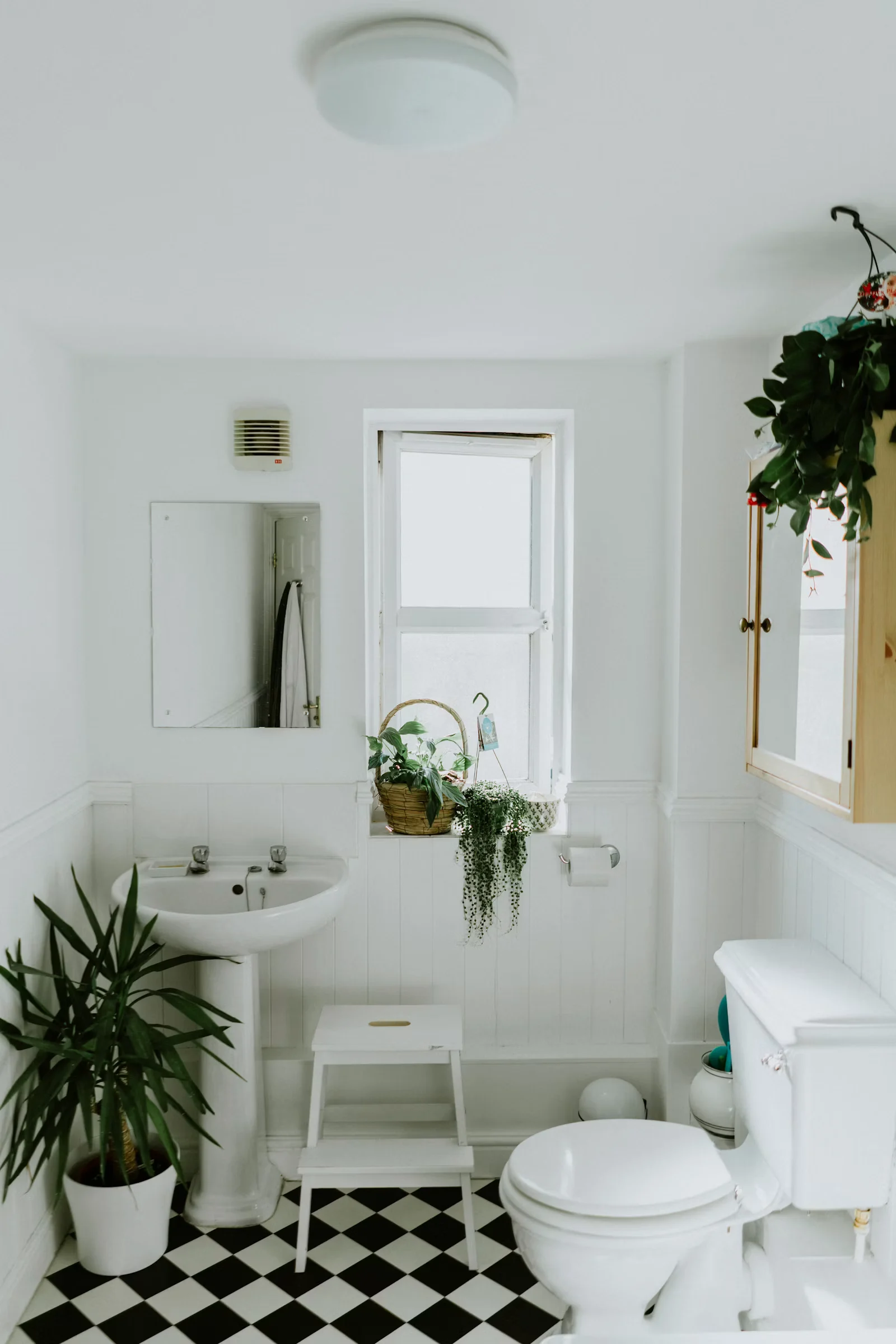 Bathroom with a soaking tub and a tall window