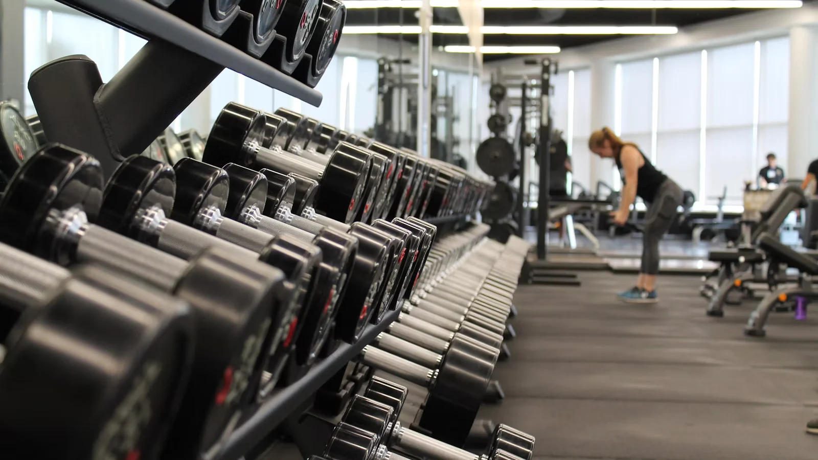 Weight room with dumbbells and rubber flooring